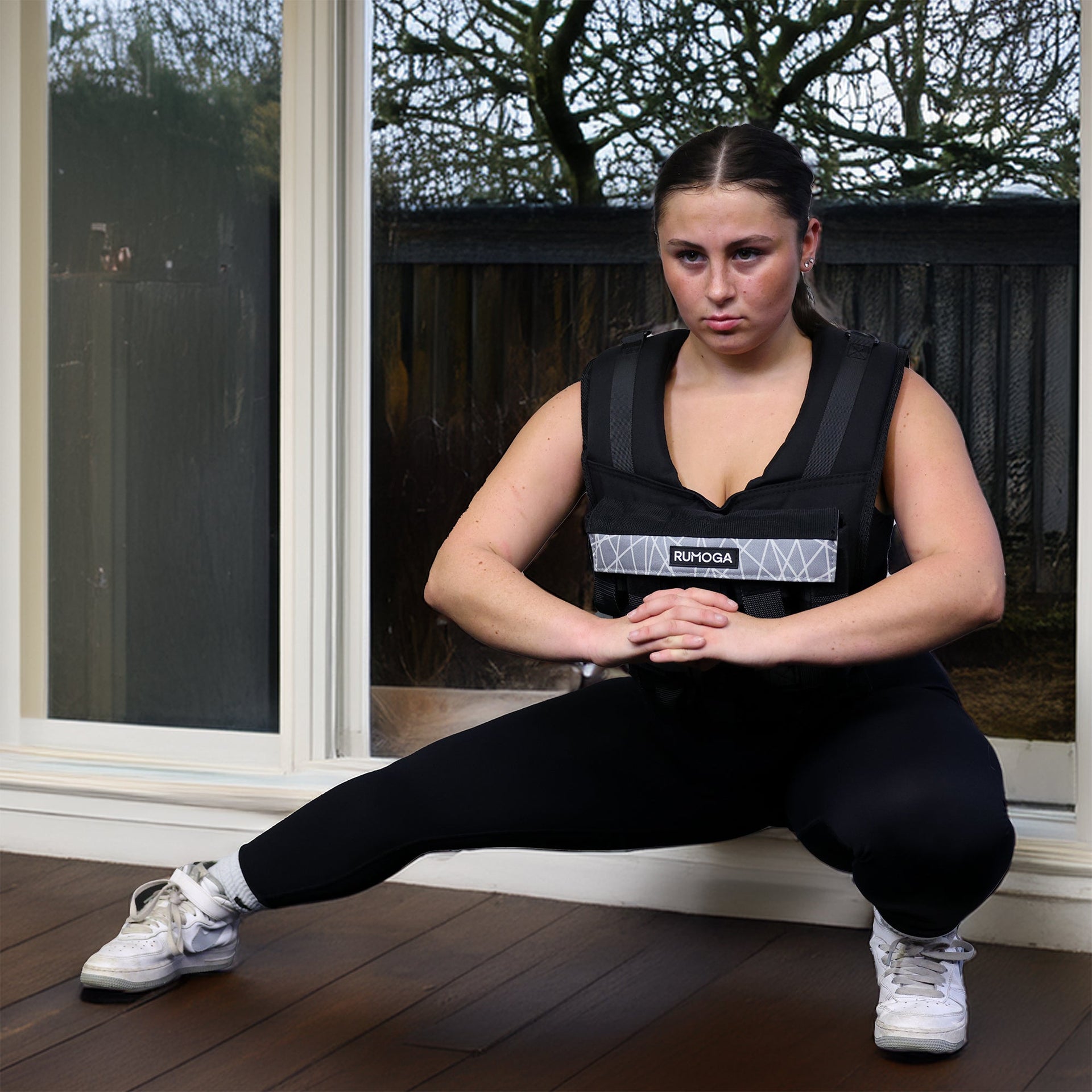 lady trying with a weight vest in the winter at home