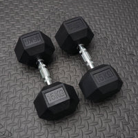 Pair of black dumbbells with '15KG' marking on a textured gray surface