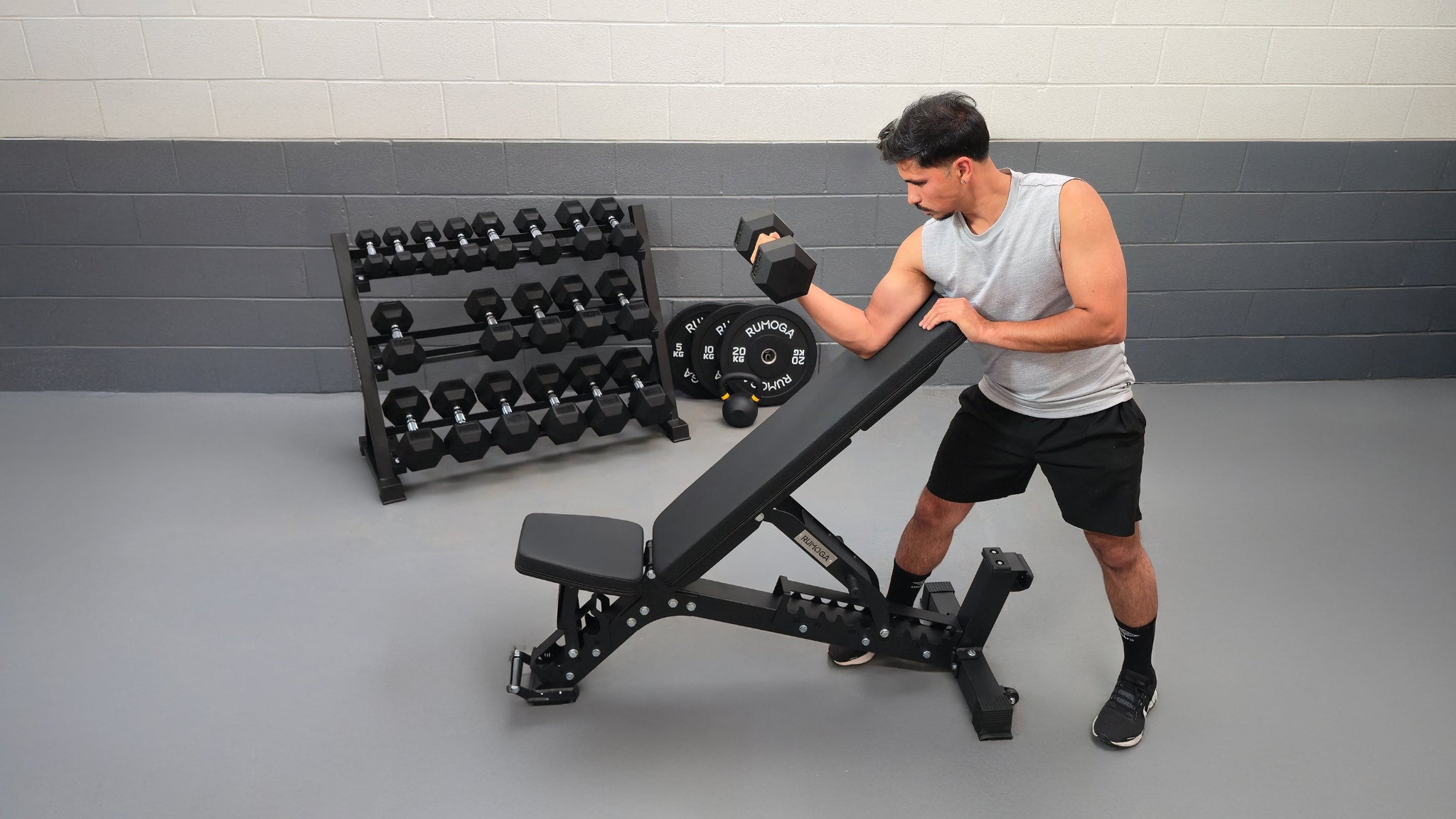 Man exercising with a hex dumbbell in a gym setting