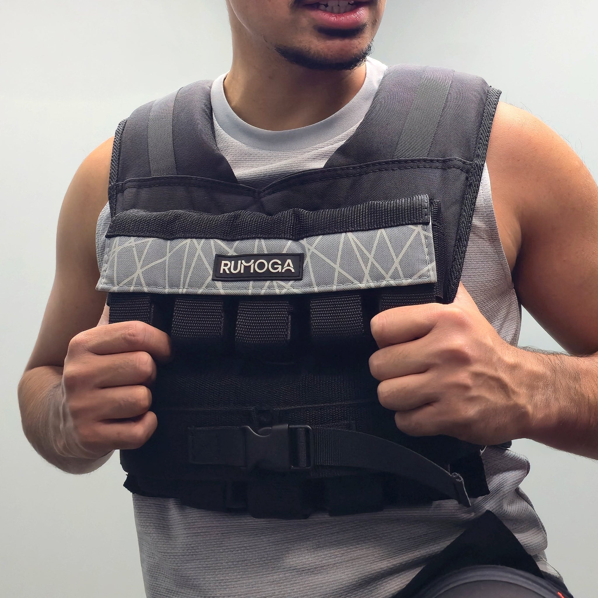 Person wearing a 20kg weighted vest with 'RUMOGA' branding on a plain background