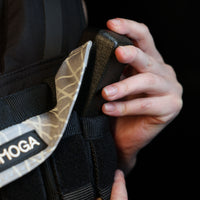 man adjusting the iron block in a weight vest 