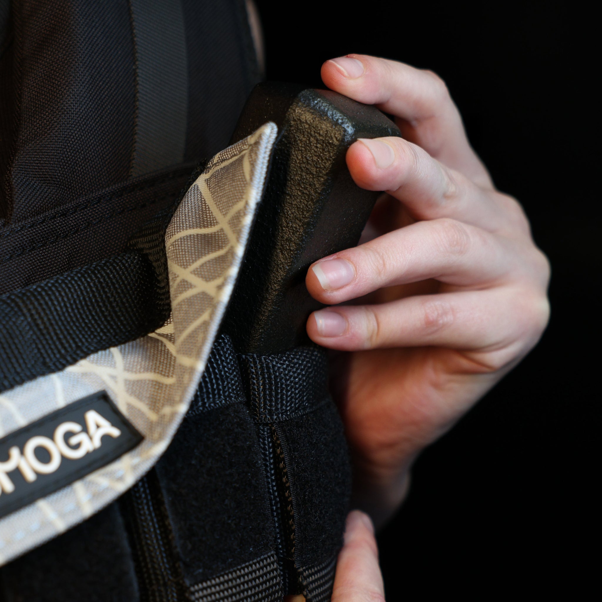man adjusting the iron block in a weight vest 